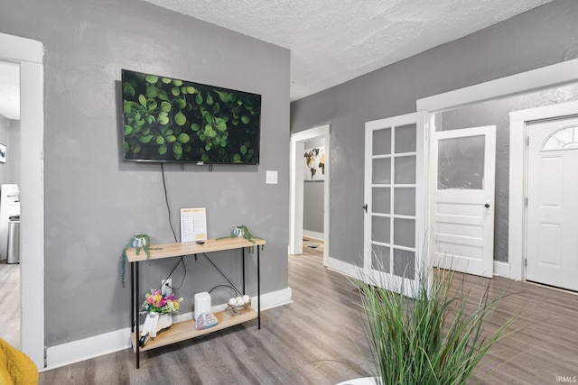 interior space featuring hardwood / wood-style floors and a textured ceiling