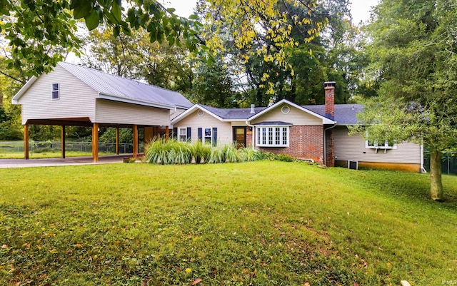 exterior space with a lawn and a carport