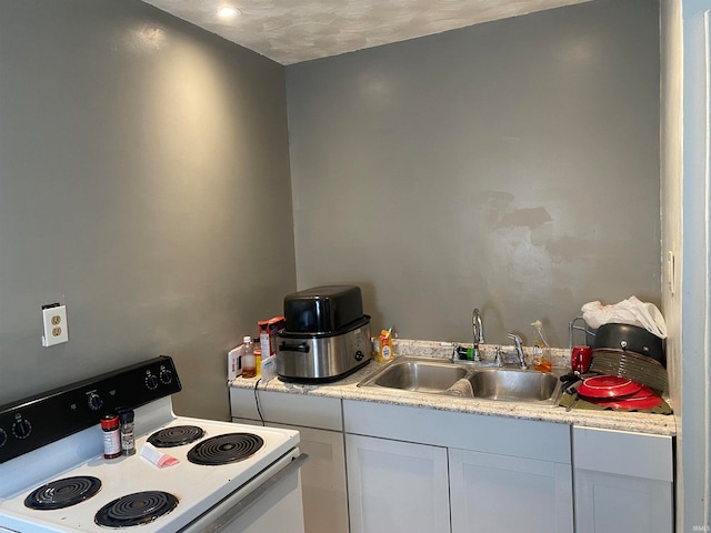 kitchen with white cabinets, a textured ceiling, white range with electric stovetop, and sink