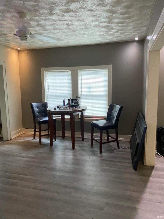 dining area featuring a textured ceiling and hardwood / wood-style floors