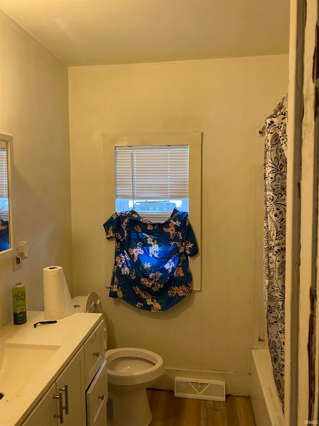 full bathroom featuring shower / bath combination with curtain, vanity, toilet, and hardwood / wood-style flooring