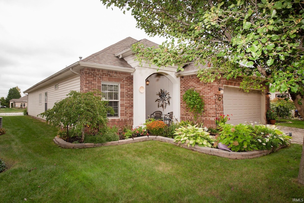 ranch-style house with a garage and a front lawn