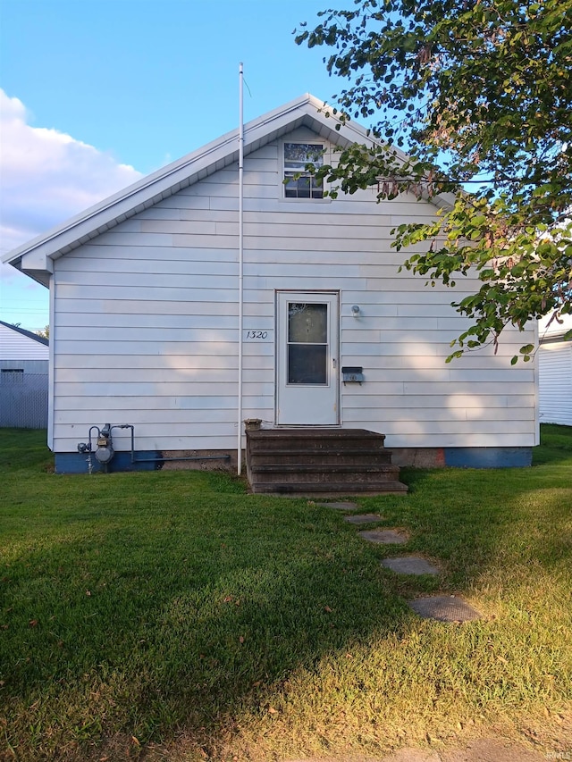 rear view of house with a yard