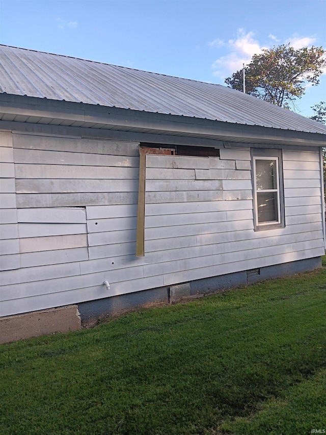 view of side of home featuring a lawn