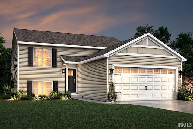 view of front facade with a garage and a lawn