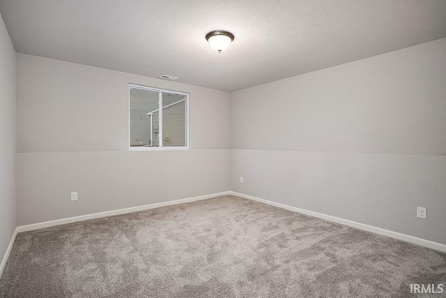 spare room featuring vaulted ceiling and carpet flooring