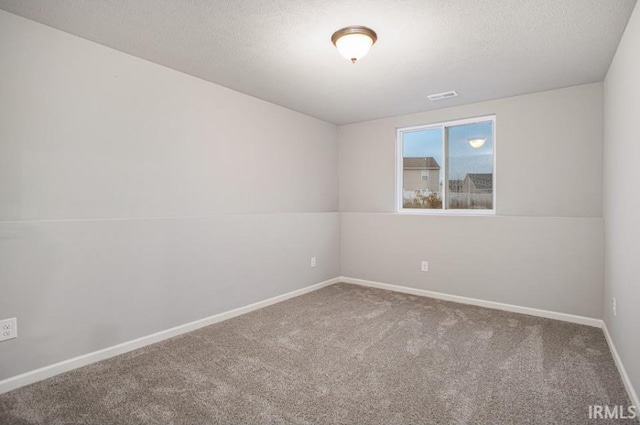 unfurnished room with lofted ceiling, a textured ceiling, and carpet flooring