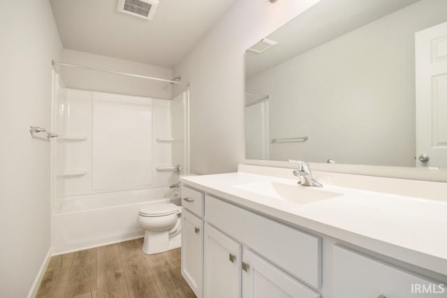 full bathroom featuring vanity, wood-type flooring, toilet, and shower / bathtub combination