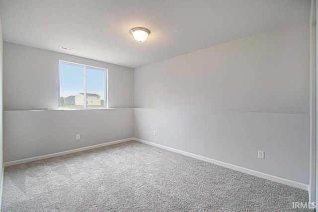 carpeted spare room featuring lofted ceiling