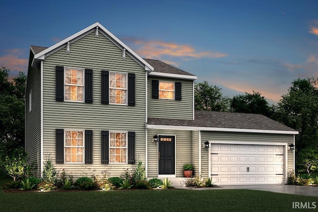 view of property with a lawn and a garage