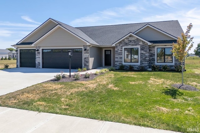 craftsman house with a front lawn and a garage