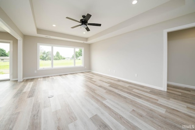 unfurnished room featuring light wood-type flooring, ceiling fan, and plenty of natural light