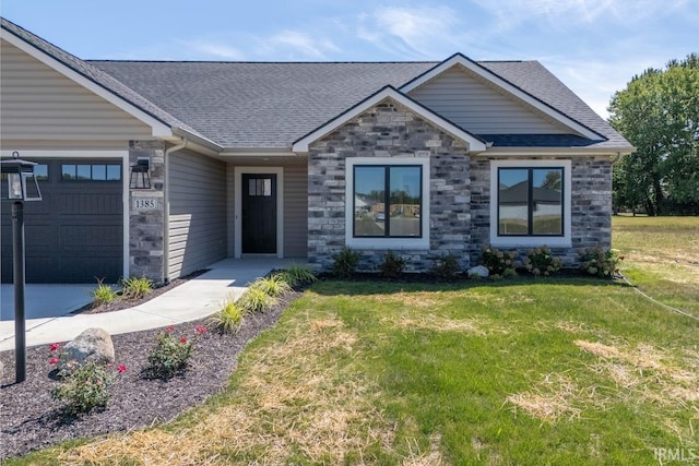 craftsman-style home with a garage and a front lawn