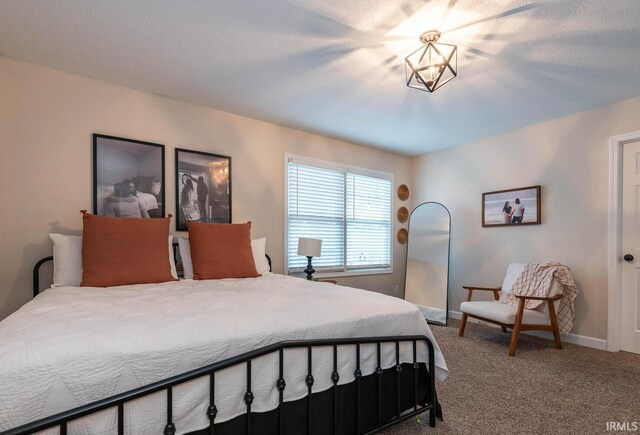 bedroom with a notable chandelier and carpet floors