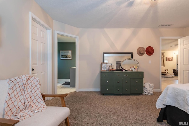 living area with light carpet and a textured ceiling