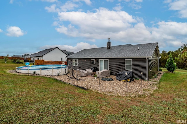 rear view of house with a lawn and a patio