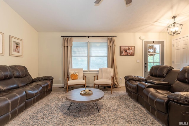 living room with ceiling fan with notable chandelier, carpet, and a wealth of natural light