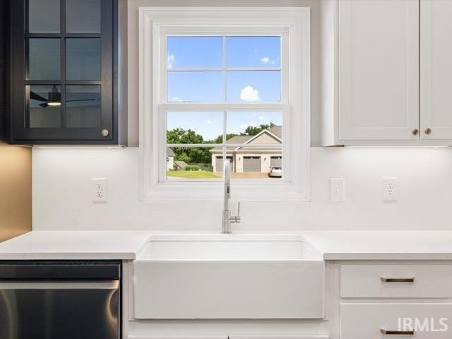 kitchen with white cabinetry and sink