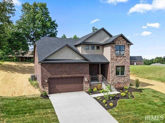 craftsman-style home with central air condition unit and a front yard