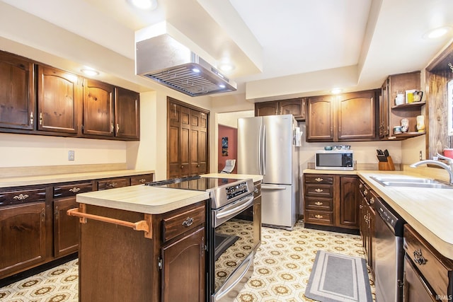 kitchen with appliances with stainless steel finishes, a center island, range hood, dark brown cabinetry, and sink