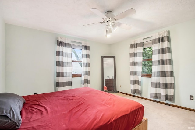 bedroom featuring ceiling fan, carpet flooring, and a textured ceiling