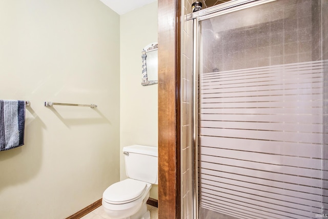 bathroom with a shower with shower door, toilet, and tile patterned flooring