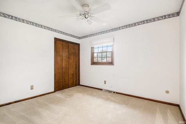 unfurnished bedroom featuring a closet, ceiling fan, and carpet flooring