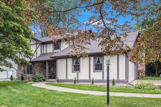 tudor-style house with a garage and a front lawn