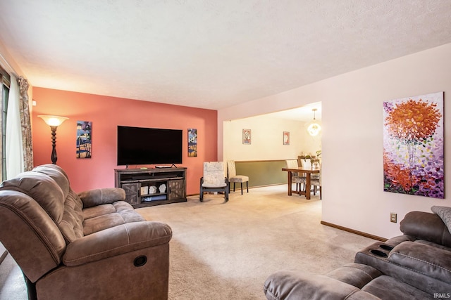 carpeted living room with a textured ceiling