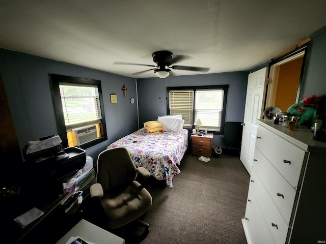 bedroom featuring cooling unit, dark carpet, and ceiling fan