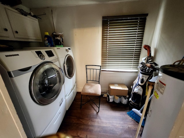 laundry room featuring dark wood-style flooring, water heater, cabinet space, and washer and clothes dryer