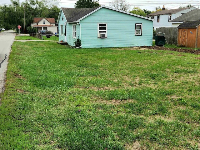 view of yard featuring cooling unit and a shed