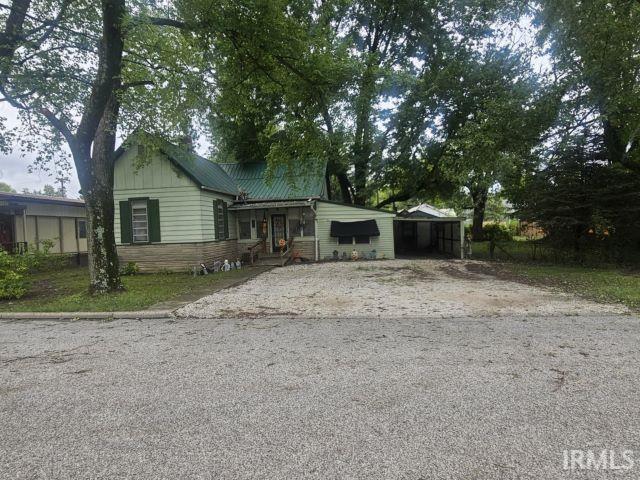 506 Meredith St, Washington, IN 47501 - view of front of home featuring driveway and a metal roof