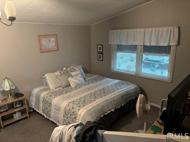 bedroom featuring carpet and vaulted ceiling