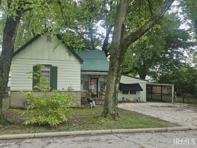 506 Meredith St, Washington, IN 47501 - view of front of home featuring driveway, board and batten siding, and a carport