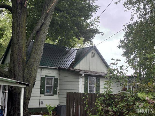 506 Meredith St, Washington, IN 47501 - view of side of property with board and batten siding and a central AC unit