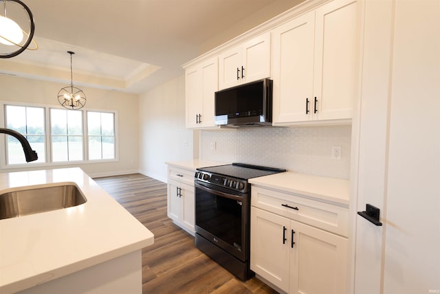 kitchen featuring pendant lighting, white cabinets, black range with electric cooktop, and dark wood-type flooring