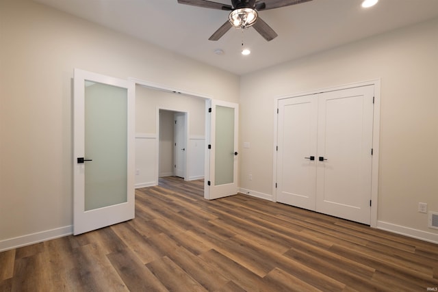 unfurnished bedroom featuring a closet, ceiling fan, and dark hardwood / wood-style flooring