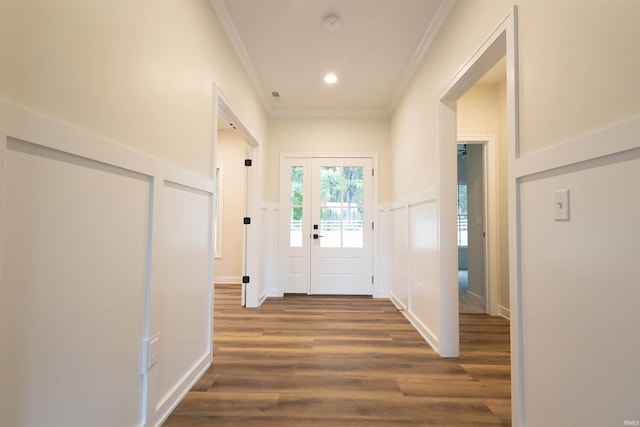 foyer entrance featuring dark hardwood / wood-style floors and crown molding