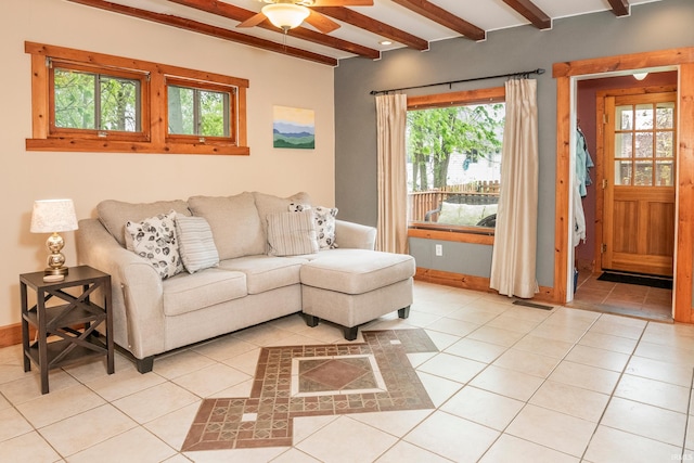 tiled living room with beamed ceiling, ceiling fan, and a wealth of natural light