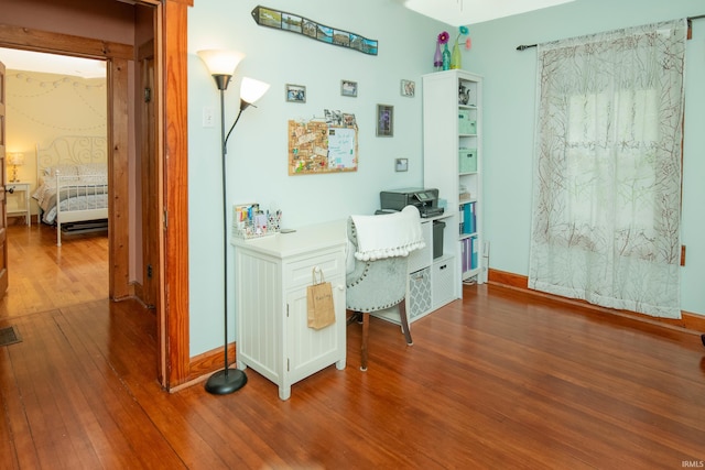 office space with wood-type flooring