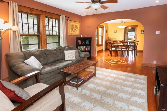 living room with ceiling fan and light wood-type flooring