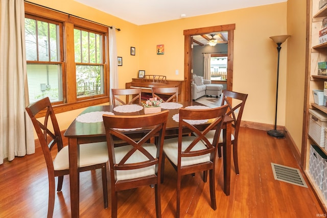 dining area with wood-type flooring, ceiling fan, and plenty of natural light