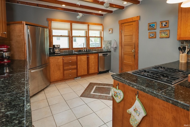 kitchen with sink, stainless steel appliances, backsplash, and beam ceiling