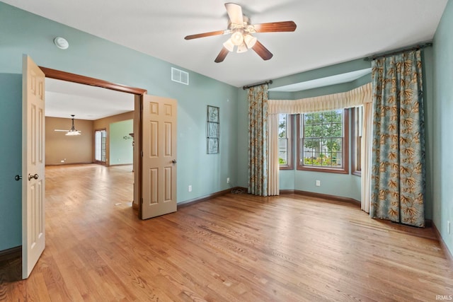 empty room with ceiling fan and light wood-type flooring