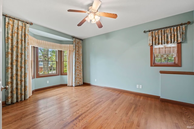 empty room featuring light hardwood / wood-style flooring and ceiling fan