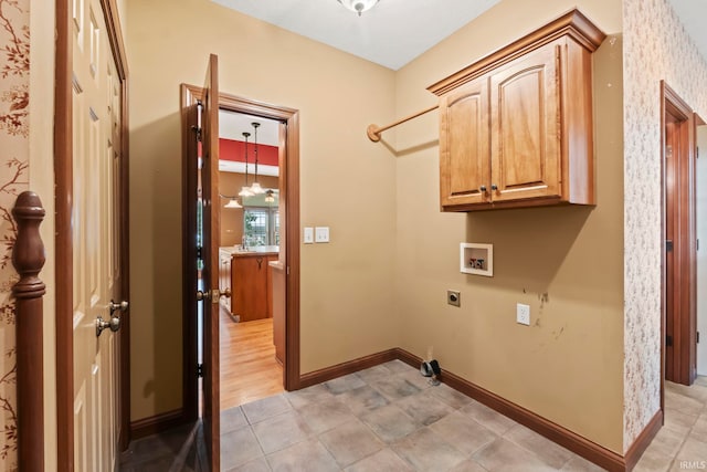 washroom featuring light hardwood / wood-style flooring, hookup for an electric dryer, washer hookup, and cabinets