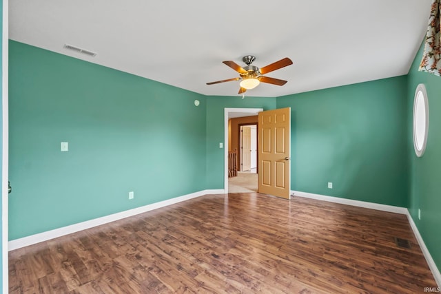 empty room featuring wood-type flooring and ceiling fan