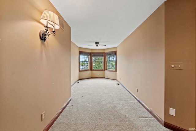 unfurnished room with light carpet and ceiling fan