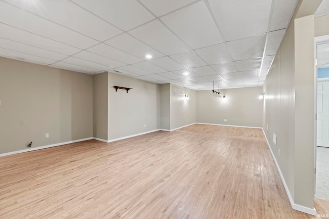 unfurnished room featuring a paneled ceiling and light hardwood / wood-style floors